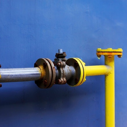 A pipe with a yellow hose attached to it.