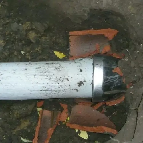 A pipe that is sitting in the ground.